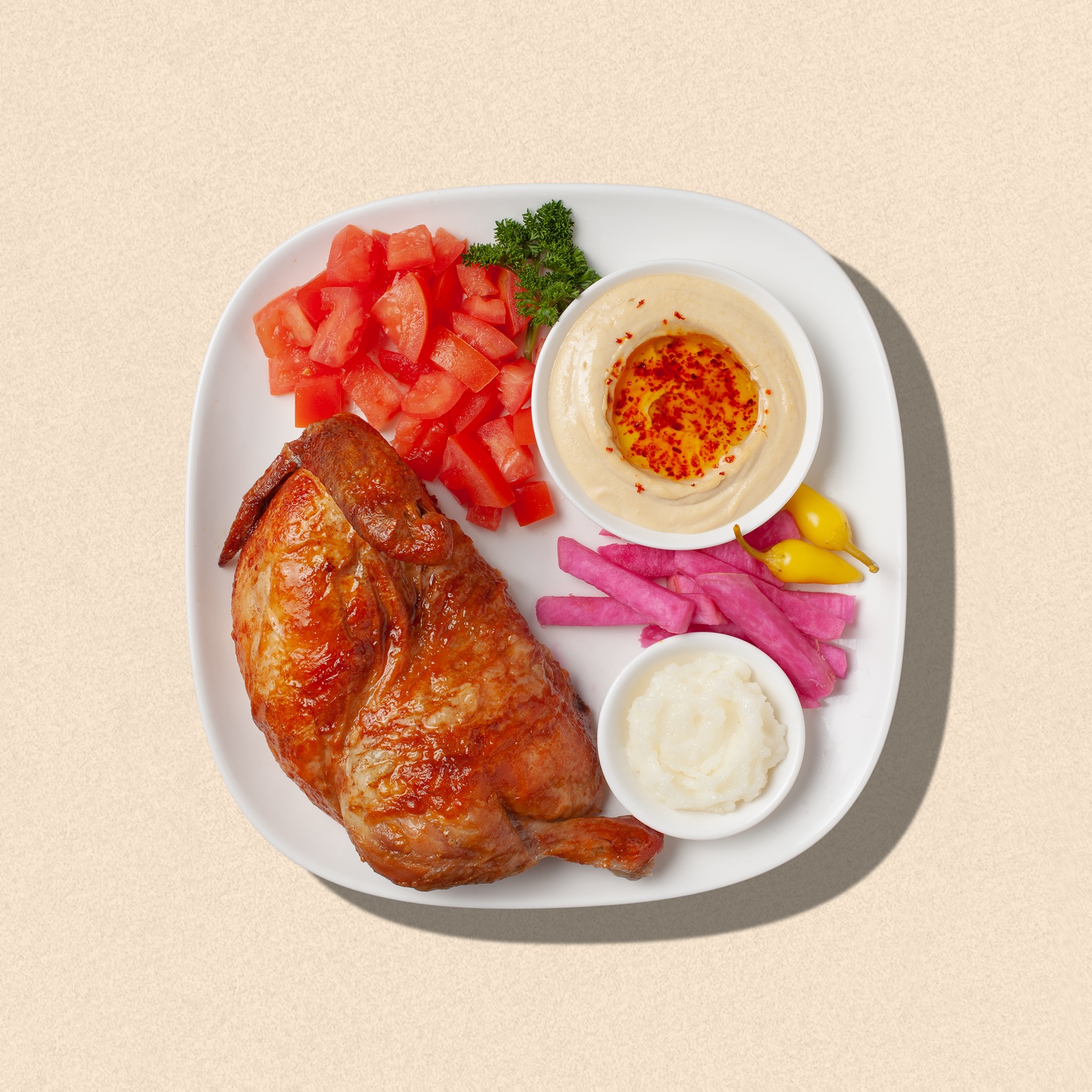 Zankou Chicken half rotisserie chicken plate with Zankou garlic sauce and hummus